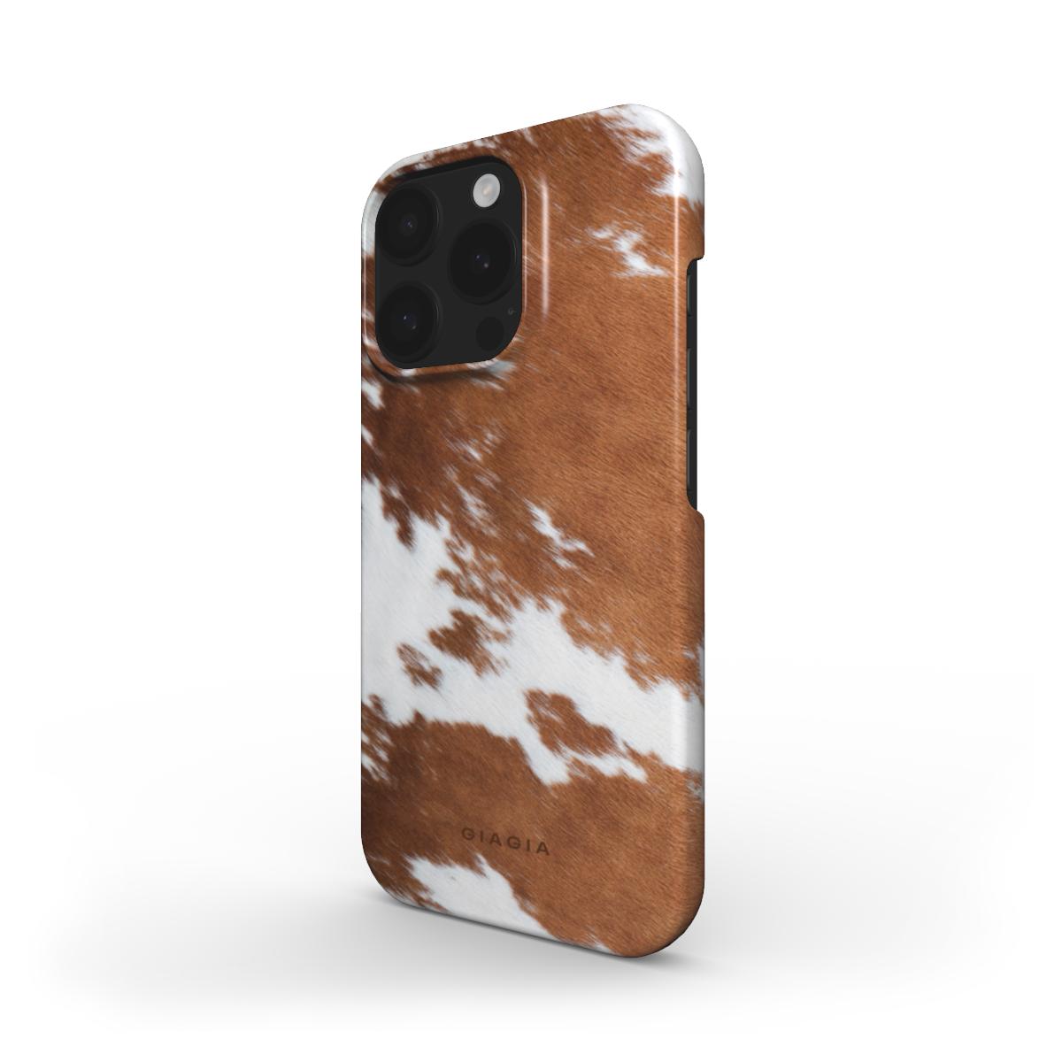 Phone case with brown and white cow print design on a white background